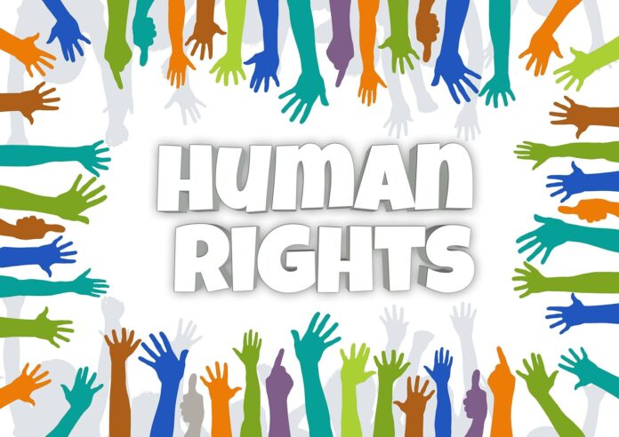 Graphic image showing coloured hands outstretched towards the words Human Rights in the middle