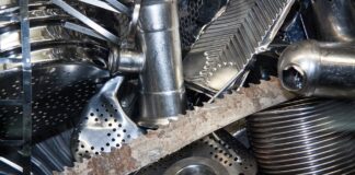 The photo shows several metal scraps, including a sawtoothed blade, a pipe, a pedal and a sink pipe union