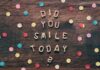 in the color photo you can see colored confetti on a brown background and did you smile today?