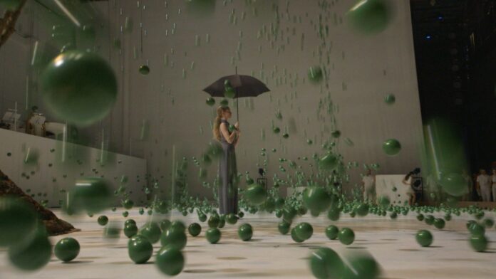 Alexander Ekman choreographer from Sweden, scene of his ballet, ballerina with umbrella, raining green balls